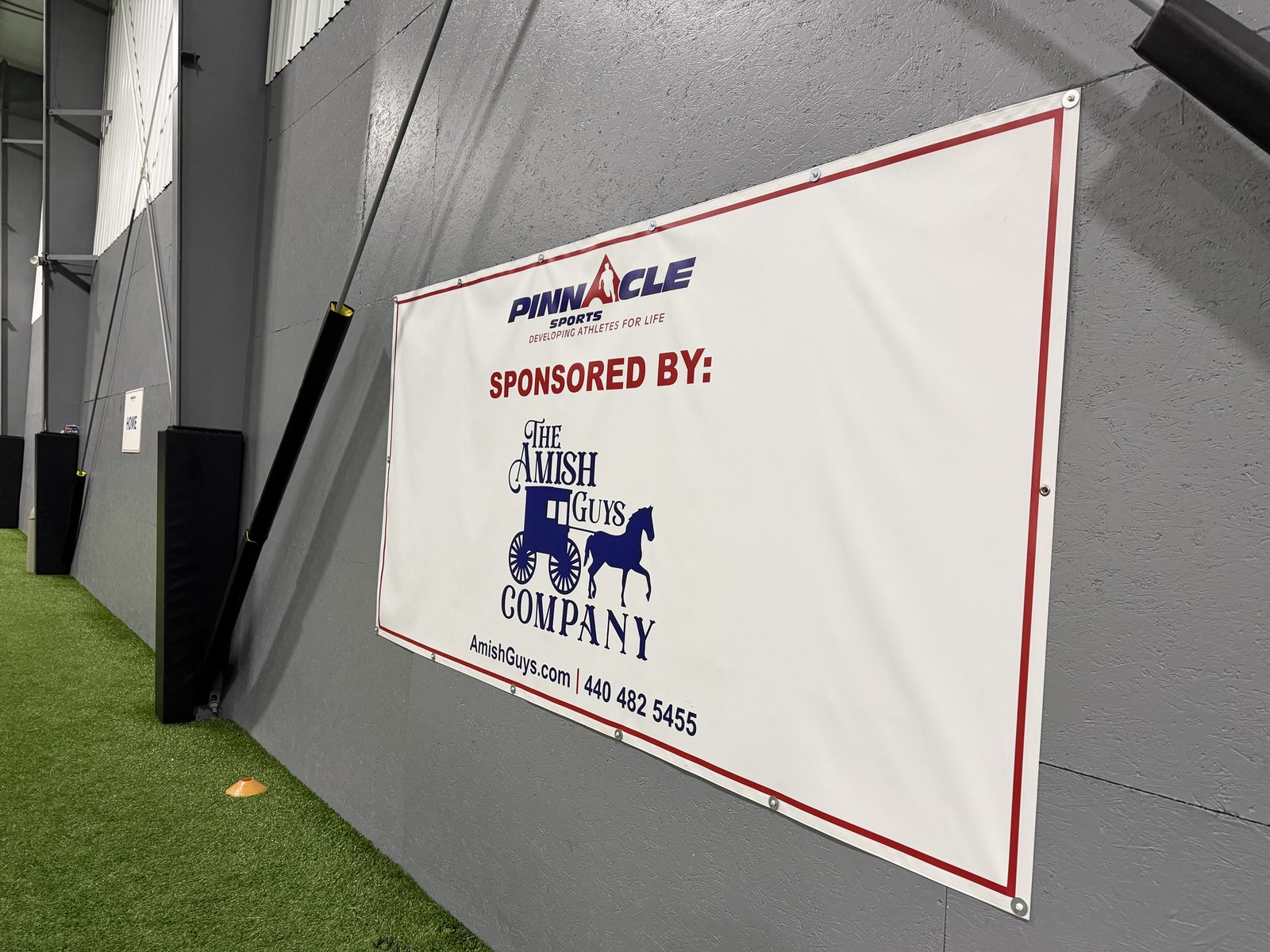 Sponsor banner mounted on the soccer arena wall at Pinnacle Sports